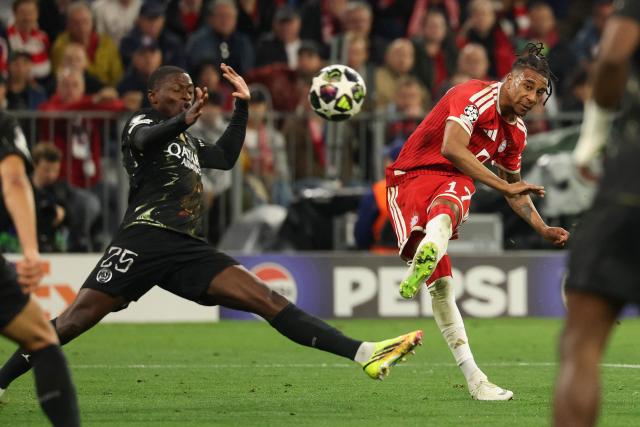 Bayern Munich's French midfielder #17 Michael Olise shoots past Paris Saint-Germain's Portuguese defender #25 Nuno Mendes (L) during the UEFA Champions League second-leg, semi-final football match between FC Bayern Munich and Paris Saint-Germain (PSG) in Munich, southern Germany on May 6, 2026. (Photo by Odd ANDERSEN / AFP)