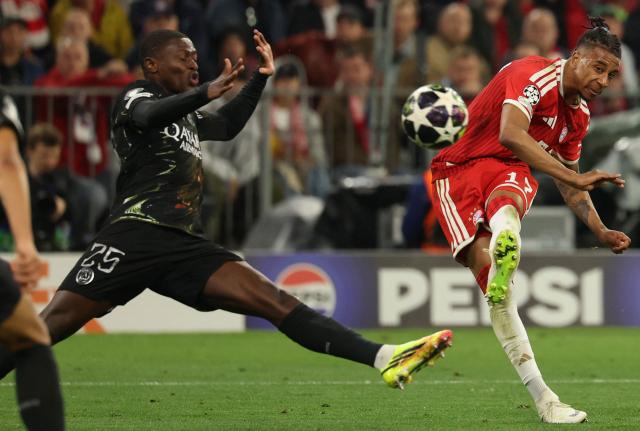 Bayern Munich's French midfielder #17 Michael Olise shoots past Paris Saint-Germain's Portuguese defender #25 Nuno Mendes (L) during the UEFA Champions League second-leg, semi-final football match between FC Bayern Munich and Paris Saint-Germain (PSG) in Munich, southern Germany on May 6, 2026. (Photo by Odd ANDERSEN / AFP)