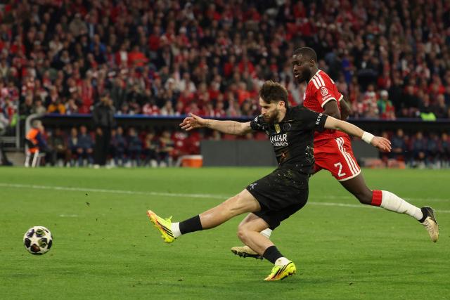 Paris Saint-Germain's Georgian forward #07 Khvicha Kvaratskhelia gets past Bayern Munich's French defender #02 Dayot Upamecano and shoots during the UEFA Champions League second-leg, semi-final football match between FC Bayern Munich and Paris Saint-Germain (PSG) in Munich, southern Germany on May 6, 2026. (Photo by Odd ANDERSEN / AFP)
