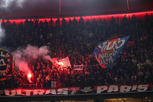 Paris fans light flares in the final minutes of the UEFA Champions League second-leg, semi-final football match between FC Bayern Munich and Paris Saint-Germain (PSG) in Munich, southern Germany on May 6, 2026. (Photo by Odd ANDERSEN / AFP)