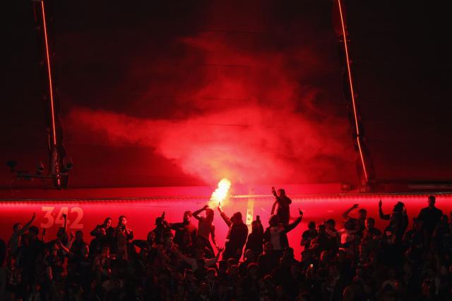 TOPSHOT - Paris fans light flares in the final minutes of the UEFA Champions League second-leg, semi-final football match between FC Bayern Munich and Paris Saint-Germain (PSG) in Munich, southern Germany on May 6, 2026. (Photo by Odd ANDERSEN / AFP)