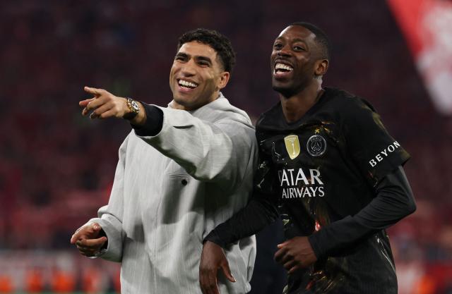 Morocco's defender #02 Achraf Hakimi and Paris Saint-Germain's French forward #10 Ousmane Dembele celebrate after the UEFA Champions League second-leg, semi-final football match between FC Bayern Munich and Paris Saint-Germain (PSG) in Munich, southern Germany on May 6, 2026. (Photo by FRANCK FIFE / AFP)