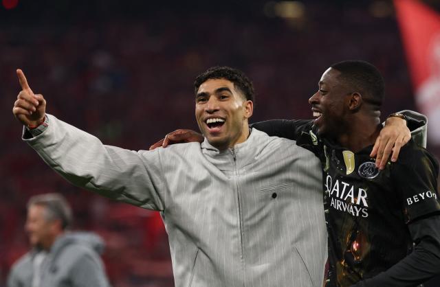 Morocco's defender #02 Achraf Hakimi and Paris Saint-Germain's French forward #10 Ousmane Dembele celebrate after the UEFA Champions League second-leg, semi-final football match between FC Bayern Munich and Paris Saint-Germain (PSG) in Munich, southern Germany on May 6, 2026. (Photo by FRANCK FIFE / AFP)