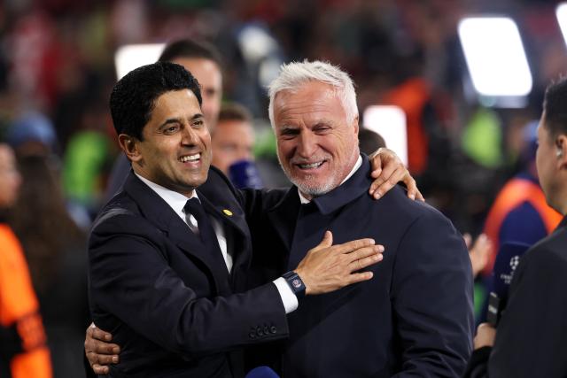 Paris Saint Germain's Qatari President Nasser al-Khelaifi (L) celebrates the team's win with French former footballer David Ginola after the UEFA Champions League second-leg, semi-final football match between FC Bayern Munich and Paris Saint-Germain (PSG) in Munich, southern Germany on May 6, 2026. (Photo by FRANCK FIFE / AFP)