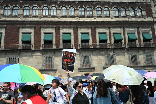Fans of South Korean K-pop band BTS wait outside the National Palace to see their idols, at the Zocalo square in Mexico City on May 6, 2026, on the eve of their concert. (Photo by YURI CORTEZ / AFP)