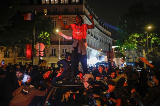 Paris Saint-Germain (PSG) supporters celebrate their team's progression to the Final of the UEFA Champions League near the Champs-Elysees after their second-leg semi-final football match against Bayern Munich, on May 6, 2026. The holdeers set up a Champions League final against Arsenal after a 1-1 second-leg draw at Bayern Munich secured a 6-5 aggregate victory. (Photo by SIMON WOHLFAHRT / AFP)