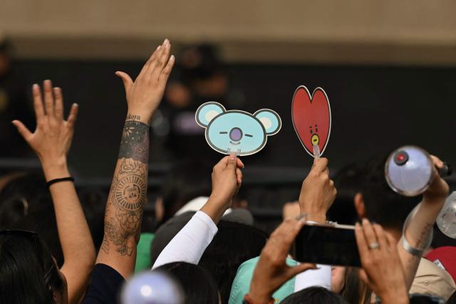 A fan of South Korean K-pop band BTS waits outside the National Palace where band members are expected to appear on the balcony at Zocalo square in Mexico City on May 6, 2026. BTS will hold three sold-out shows at Estadio GNP Seguros in Mexico city on May 7, 9, and 10. (Photo by YURI CORTEZ / AFP)
