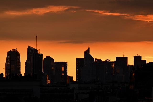 This photograph taken from Paris shows a sunset on a cloudy sky over La Defense on May 6, 2026. (Photo by Christophe DELATTRE / AFP)