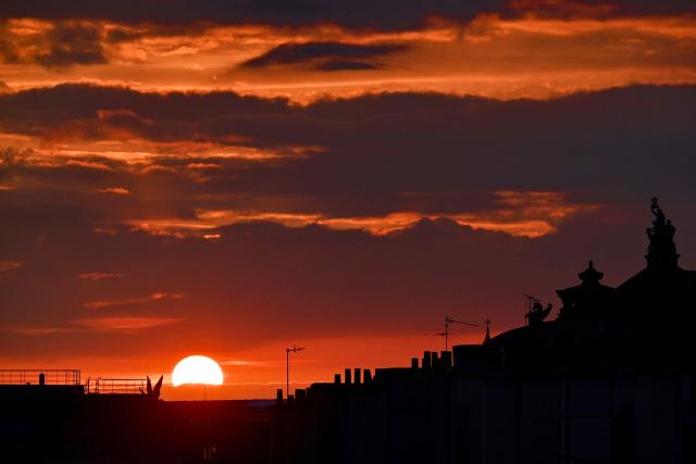 The sun sets on a cloudy sky over Paris on May 6, 2026. (Photo by Christophe DELATTRE / AFP)