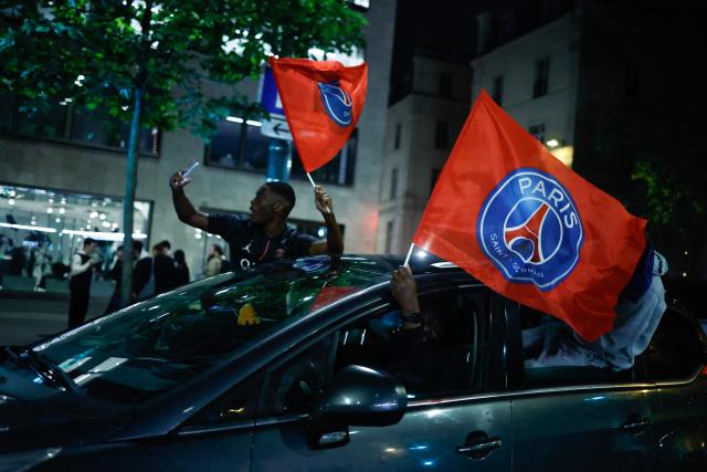 Paris Saint-Germain (PSG) supporters celebrate their team's progression to the Final of the UEFA Champions League near the Champs-Elysees after their second-leg semi-final football match against Bayern Munich, in Paris, on May 6, 2026. The holders set up a Champions League final against Arsenal after a 1-1 second-leg draw at Bayern Munich secured a 6-5 aggregate victory. (Photo by SIMON WOHLFAHRT / AFP)