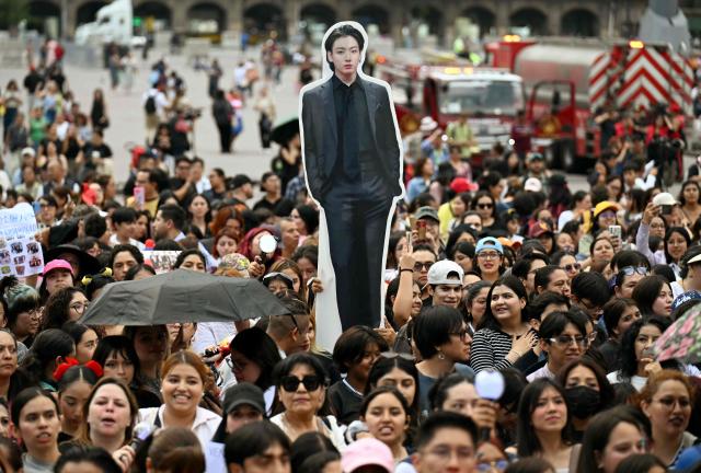 Fans of South Korean K-pop band BTS wait outside the National Palace where band members are expected to appear on the balcony at Zocalo square in Mexico City on May 6, 2026. BTS will hold three sold-out shows at Estadio GNP Seguros in Mexico city on May 7, 9, and 10. (Photo by YURI CORTEZ / AFP)