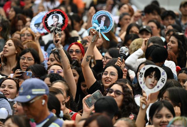 Fans of South Korean K-pop band BTS wait outside the National Palace where band members are expected to appear on the balcony at Zocalo square in Mexico City on May 6, 2026. BTS will hold three sold-out shows at Estadio GNP Seguros in Mexico city on May 7, 9, and 10. (Photo by YURI CORTEZ / AFP)