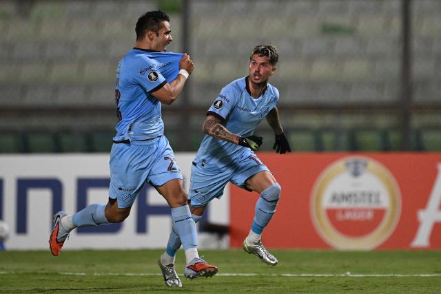 Bolivar's midfielder #23 Leonel Justiniano (L) celebrates with teammate Argentine forward #17 Patricio Rodriguez after scoring his team's first goal during the Copa Libertadores group stage football match between Venezuela's Deportivo La Guaira and Bolivia's Bolivar at the Olimpico de la UCV stadium in Caracas on May 6, 2026. (Photo by Federico PARRA / AFP)
