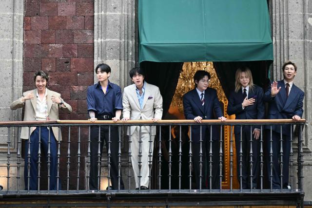 South Korean K-pop band BTS acknowledge fans from the balcony of the National Palace, at Zocalo square in Mexico City on May 6, 2026. BTS will hold three sold-out shows at Estadio GNP Seguros in Mexico city on May 7, 9, and 10. (Photo by YURI CORTEZ / AFP)