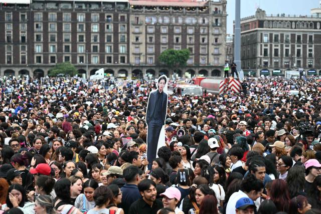 Fans of South Korean K-pop band BTS gather outside the National Palace waiting for the band members to appear on the balcony, at Zocalo square in Mexico City on May 6, 2026. BTS will hold three sold-out shows at Estadio GNP Seguros in Mexico city on May 7, 9, and 10. (Photo by YURI CORTEZ / AFP)
