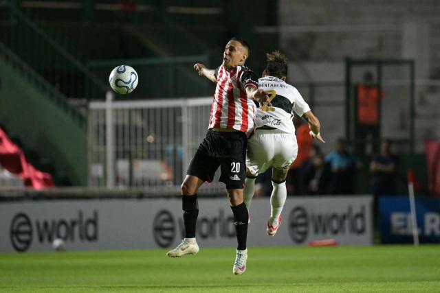 Barracas Central's Uruguayan forward #20 Jhonatan Candia and Olimpia's Uruguayan defender #02 Bryan Bentaberry fight for the ball during the Copa Sudamericana group stage football match between Argentina's Barracas Central and Paraguay's Olimpia at the Florencio Sola stadium in Banfield, Buenos Aires province, Argentina on May 6, 2026. (Photo by Juan MABROMATA / AFP)