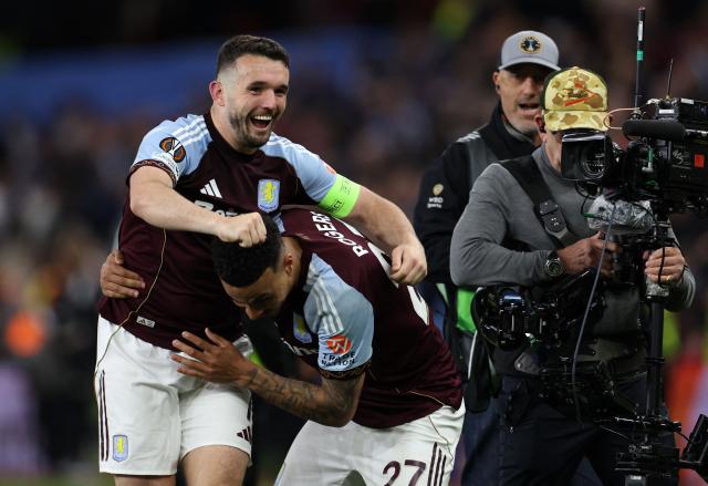 Aston Villa's Scottish midfielder  #07 John McGinn celebrates with Aston Villa's English midfielder #27 Morgan Rogers after the UEFA Europa League, semi-final second-leg football match between Aston Villa and Nottingham Forest at Villa Park in Birmingham, central England on May 7, 2026. Aston Villa won the match 4-0. (Photo by Darren Staples / AFP)
