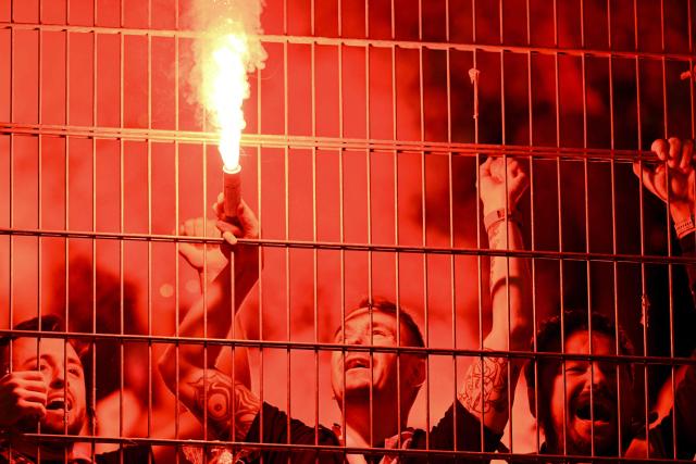 Rayo Vallecano's supporters light flares and cheer for their team during the UEFA Conference League semi-final second leg football match between RC Strasbourg Alsace and Rayo Vallecano de Madrid at Stade de la Meinau in Strasbourg, eastern France on May 7, 2026. (Photo by SEBASTIEN BOZON / AFP)