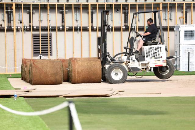 Workers install the pitch at New York New Jersey Stadium (temporarily renamed from MetLife stadium) ahead of the 2026 FIFA World Cup, in East Rutherford, New Jersey on May 7, 2026. (Photo by CHARLY TRIBALLEAU / AFP)