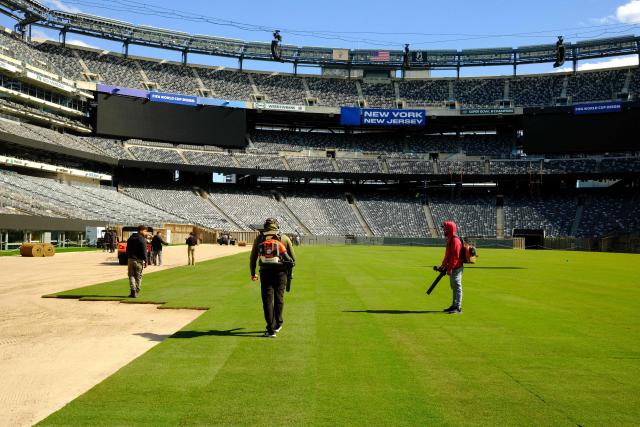 Workers install the pitch at New York New Jersey Stadium (temporarily renamed from MetLife stadium) ahead of the 2026 FIFA World Cup, in East Rutherford, New Jersey on May 7, 2026. (Photo by CHARLY TRIBALLEAU / AFP)