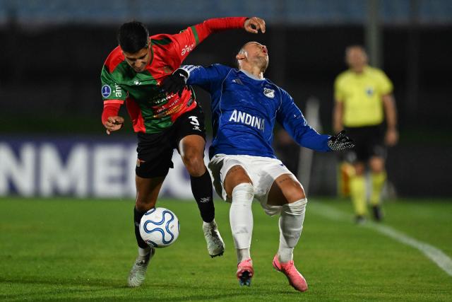 Boston River's defender #3 Marco Mancebo (L) and Millonarios' forward #23 Leonardo Castro fight for the ball during the Copa Sudamericana group stage football match between Uruguay's Boston River and Colombia's Millonarios at the Centenario stadium in Montevideo on May 7, 2026. (Photo by Eitan ABRAMOVICH / AFP)