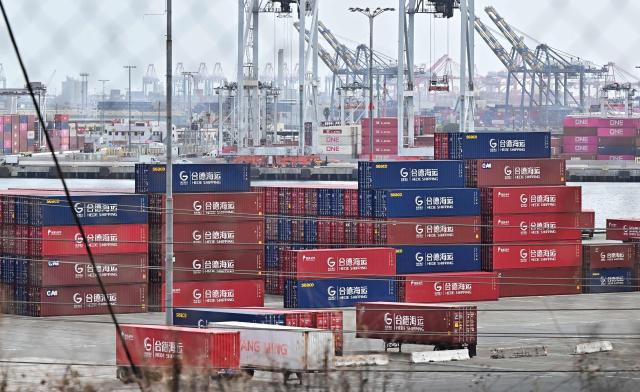 (FILES) Shipping containers from Hede Shipping, from the Chinese state-owned Hebei Port Group, are seen stacked at the Port of Los Angeles in Los Angeles, California on October 13, 2025. A US trade court on Thursday dealt President Donald Trump a fresh setback, ruling against the 10-percent global tariffs he instituted after the Supreme Court struck down many earlier duties. (Photo by Frederic J. BROWN / AFP)