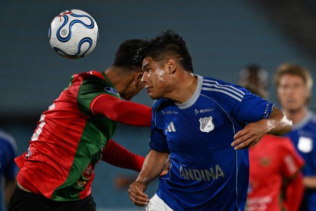 Millonarios' defender #17 Jorge Arias (R) heads the ball during the Copa Sudamericana group stage football match between Uruguay's Boston River and Colombia's Millonarios at the Centenario stadium in Montevideo on May 7, 2026. (Photo by Eitan ABRAMOVICH / AFP)