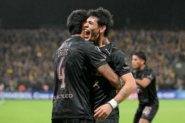 Platense's defender #04 Agustin Lagos celebrates with teammate midfielder #10 Franco Zapiola after scoring his team's first goal during the Copa Libertadores group stage football match between Argentina's Platense and Uruguay's Penarol at the Ciudad de Vicente Lopez stadium in Vicente Lopez, Buenos Aires province, Argentina on May 7, 2026. (Photo by JUAN MABROMATA / AFP)