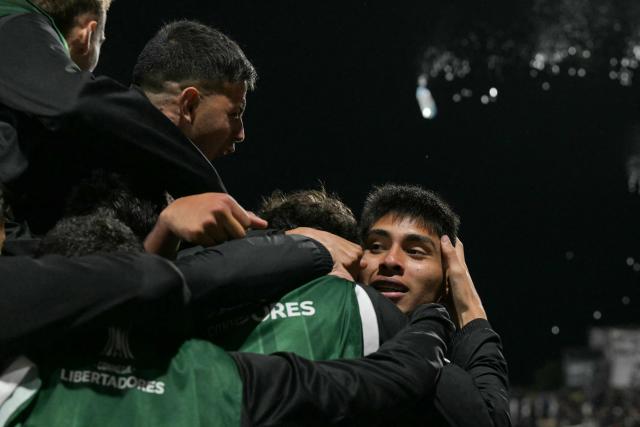 Platense's defender #04 Agustin Lagos (R) celebrates with teammates after scoring his team's first goal during the Copa Libertadores group stage football match between Argentina's Platense and Uruguay's Penarol at the Ciudad de Vicente Lopez stadium in Vicente Lopez, Buenos Aires province, Argentina on May 7, 2026. (Photo by JUAN MABROMATA / AFP)