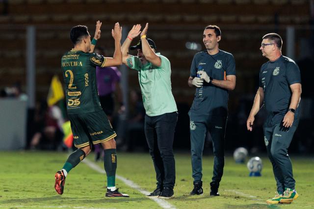 Mirassol's defender #02 Lucas Oliveira celebrates with Mirassol's head coach Rafael Guanaes during the Copa Libertadores group stage football match between Brazil's Mirassol and Ecuador's Liga de Quito at the Jose Maria de Campos Maia stadium in Mirassol, state of Sao Paulo, Brazil on May 7, 2026. (Photo by RAPHA MARQUES / AFP)