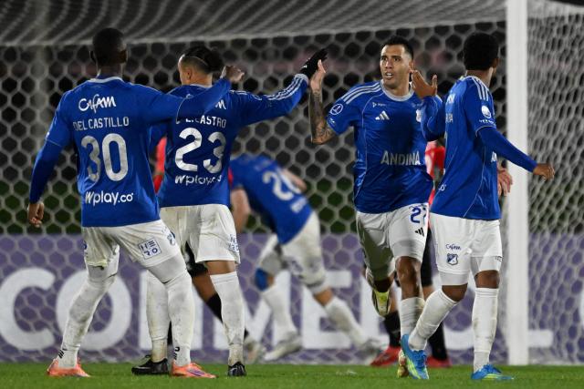 Millonarios' Argentine forward #27 Rodrigo Contreras celebrates with teammates after scoring a penalty during the Copa Sudamericana group stage football match between Uruguay's Boston River and Colombia's Millonarios at the Centenario stadium in Montevideo on May 7, 2026. (Photo by Eitan ABRAMOVICH / AFP)