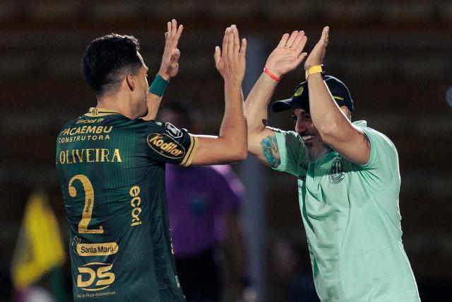 Mirassol's defender #02 Lucas Oliveira celebrates with Mirassol's head coach Rafael Guanaes after scoring the team's first goal during the Copa Libertadores group stage football match between Brazil's Mirassol and Ecuador's Liga de Quito at the Jose Maria de Campos Maia stadium in Mirassol, state of Sao Paulo, Brazil on May 7, 2026. (Photo by RAPHA MARQUES / AFP)