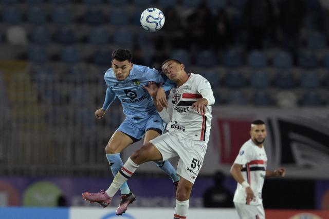 O'Higgins Paraguayan forward #09 Arnaldo Castillo and Sao Paulo's defender #54 Luis Osorio jump for a header during the Copa Sudamericana group stage football match between Chile's O'Higgins and Brazil's Sao Paulo at the Codelco El Teniente stadium in Rancagua, Chile on May 7, 2026. (Photo by Rodrigo ARANGUA / AFP)