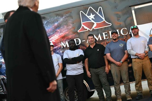 US President Donald Trump speaks with workers who have been painting the Lincoln Memorial Reflecting Pool in Washington, DC, on May 7, 2026. Workers have been resurfacing the bottom of Washington's famous Lincoln Memorial Reflecting Pool with "American flag blue"-colored material used in swimming pools, following an order by US President Donald Trump. (Photo by Kent NISHIMURA / AFP)
