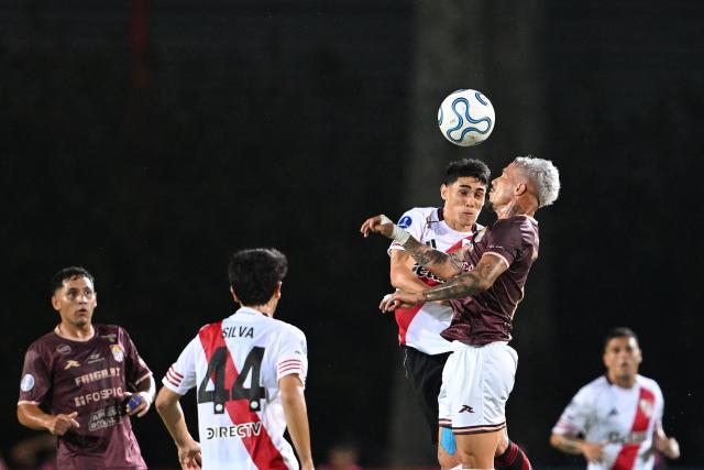River Plate's midfielder #39 Santiago Lencina AND Carabobo's forward #07 Edson Tortolero jump for a header during the Copa Sudamericana group stage football match between Venezuela's Carabobo FC and Argentina's River Plate at the Misael Delgado stadium in Valencia, Carabobo state, Venezuela on May 7, 2026. (Photo by Federico PARRA / AFP)