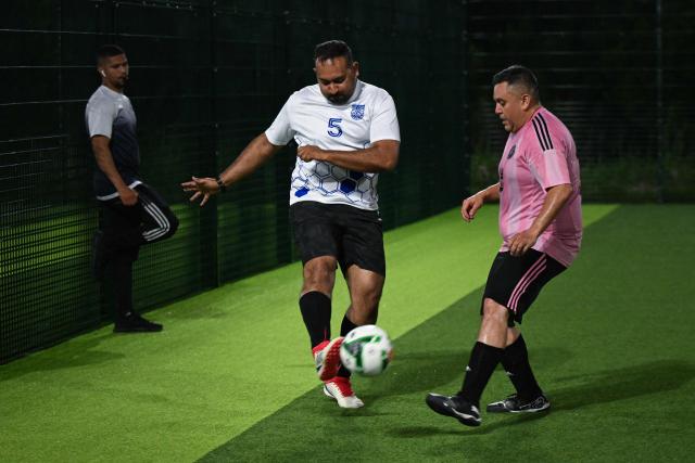 Participants in the “Man vs Fat Soccer” weight-loss program play a soccer game, in Houston, Texas on May 5, 2026. In a soccer league of big men trying to lose weight, the five-a-side teams feature names like OB City, Big Bananas and Heavy Touch FC. And players can score before the game even starts, standing on a scale and winning goal points for chipping away at their weight problems. Welcome to Man vs. Fat Soccer, a tongue in cheek Texas league that is thriving as Houston prepares to join cities elsewhere in the United States in hosting World Cup games, along with Mexico and Canada. (Photo by RONALDO SCHEMIDT / AFP)