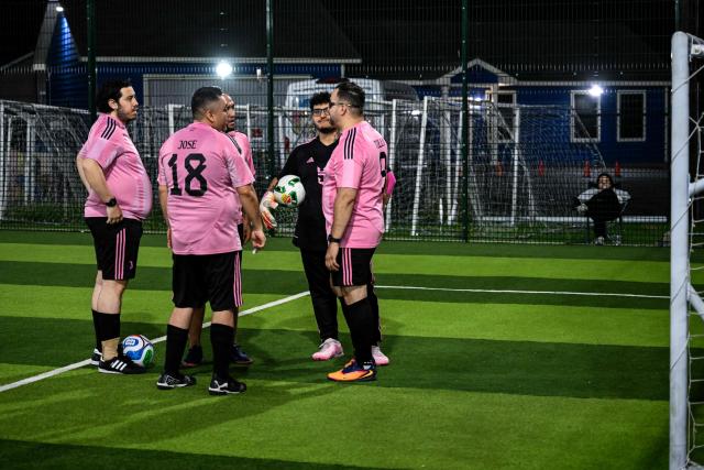Participants in the “Man vs Fat Soccer” weight-loss program play a soccer game, in Houston, Texas on May 5, 2026. In a soccer league of big men trying to lose weight, the five-a-side teams feature names like OB City, Big Bananas and Heavy Touch FC. And players can score before the game even starts, standing on a scale and winning goal points for chipping away at their weight problems. Welcome to Man vs. Fat Soccer, a tongue in cheek Texas league that is thriving as Houston prepares to join cities elsewhere in the United States in hosting World Cup games, along with Mexico and Canada. (Photo by RONALDO SCHEMIDT / AFP)