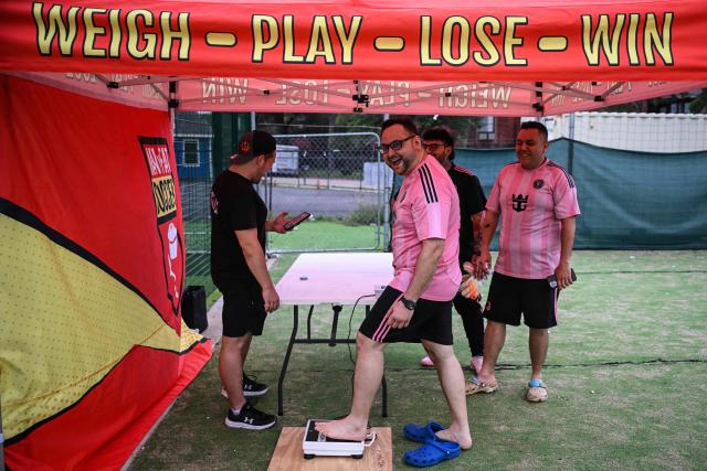 Participants in the “Man vs Fat Soccer” weight-loss program weigh in before playing a soccer game, in Houston, Texas on May 5, 2026. In a soccer league of big men trying to lose weight, the five-a-side teams feature names like OB City, Big Bananas and Heavy Touch FC. And players can score before the game even starts, standing on a scale and winning goal points for chipping away at their weight problems. Welcome to Man vs. Fat Soccer, a tongue in cheek Texas league that is thriving as Houston prepares to join cities elsewhere in the United States in hosting World Cup games, along with Mexico and Canada. (Photo by RONALDO SCHEMIDT / AFP)