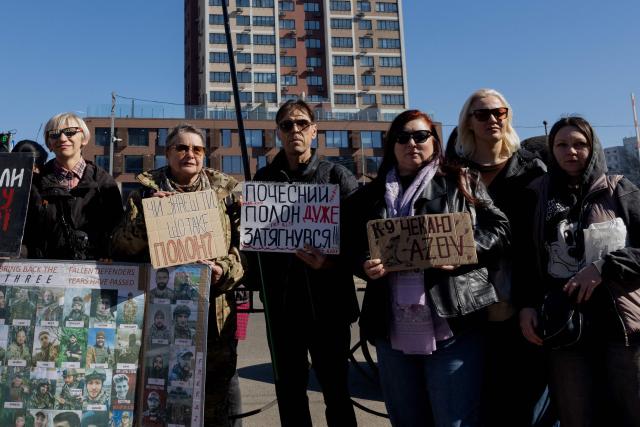 Natalia Kravtsova (3rd R), 52 years old, mother of Artem an Azov fighter detained since 2022 take part in a rally for Ukrainian prisoners of war calling to speed up their exchange in Kyiv on March 22, 2026, amid the Russian invasion of Ukraine. Thousands of Ukrainian soldiers and civilians have been or are currently subjected to physical and psychological abuse in detention centres in Russia and in occupied Ukraine, according to testimonies gathered by AFP, as well as reports from numerous NGOs, media outlets and the OSCE. Natalia Kravtsovas son, Artem, a fighter of the nationalist Azov Brigade, was taken prisoner in Mariupol in May 2022. A year later, the 52-year-old woman received confirmation from the Red Cross that he was being held captive, but no further information. (Photo by Tetiana DZHAFAROVA / AFP)