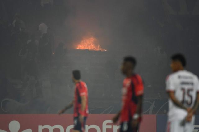Medellin fans set fire in the stands during the Copa Libertadores group stage football match between Colombia's Independiente Medellin and Brazil's Flamengo at the Atanasio Girardot stadium in Medellin, Antioquia department, Colombia on May 7, 2026. (Photo by Jaime SALDARRIAGA / AFP)