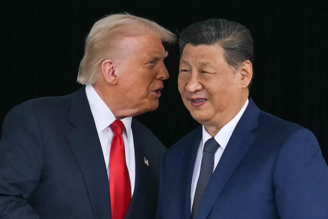 (FILES) US President Donald Trump (L) talks to China's President Xi Jinping as they shake hands after their talks at the Gimhae Air Base, located next to the Gimhae International Airport in Busan on October 30, 2025. US President Donald Trump is due to visit China on May 14-15, 2026, where he is expected to meet with leader Xi Jinping, after delaying an earlier summit because of the Iran war. (Photo by ANDREW CABALLERO-REYNOLDS / AFP)