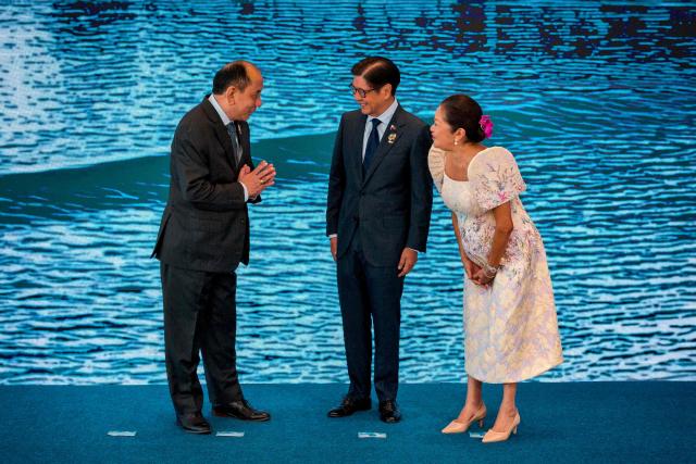 Myanmar Permanent Secretary of the Ministry of Foreign Affairs U Hau Khan Sum (L) is greeted by Philippine President Ferdinand Marcos Jr. and his wife Liza Araneta Marcos during a welcome ceremony during the 48th Association of Southeast Asian Nations (ASEAN) summit in Cebu, central Philippines on May 8, 2026. (Photo by Ezra Acayan / POOL / AFP)