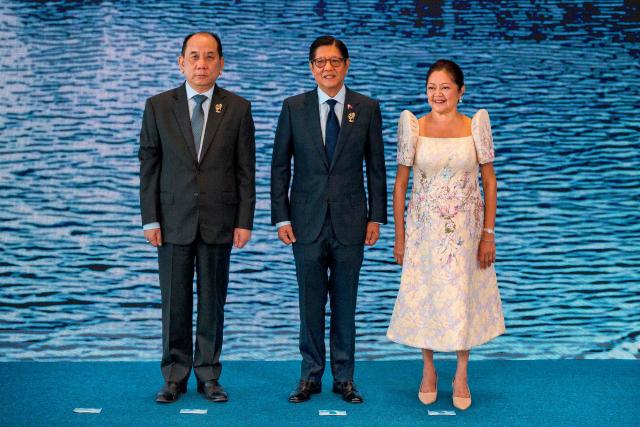 Myanmar Permanent Secretary of the Ministry of Foreign Affairs U Hau Khan Sum (L) poses for a photo with Philippine President Ferdinand Marcos Jr. and his wife Liza Araneta Marcos during a welcome ceremony during the 48th Association of Southeast Asian Nations (ASEAN) summit in Cebu, central Philippines on May 8, 2026. (Photo by Ezra Acayan / POOL / AFP)