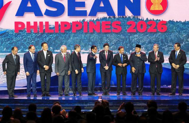 (L-R) Myanmar's Permanent Secretary of the Ministry of Foreign Affairs U Hau Khan Sum, Malaysia's Prime Minister Anwar Ibrahim, Thailand's Prime Minister Anutin Charnvirakul, East Timor's Prime Minister Xanana Gusmao, Vietnam's Prime Minister Le Minh Hung, Philippine President Ferdinand Marcos Jr., Singapore's Prime Minister Lawrence Wong, Brunei's Sultan Hassanal Bolkiah, Indonesia's President Prabowo Subianto, Cambodia's Prime Minister Hun Manet and Laos Prime Minister Sonexay Siphandone leave after a group photo during the opening ceremony of the 48th Association of Southeast Asian Nations (ASEAN) summit in Cebu, central Philippines on May 8, 2026. (Photo by Aaron FAVILA / POOL / AFP)