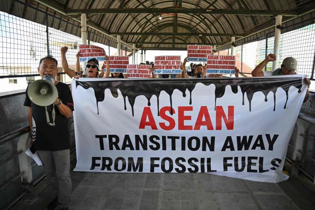 Environmental activists hold placards as they shout slogans during a rally on a footbridge coinciding with the opening ceremony of the Association of Southeast Asian Nations (ASEAN)summit in Cebu on May 8, 2026. (Photo by Ted ALJIBE / AFP)