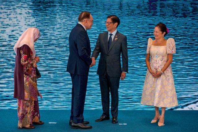 Malaysian Prime Minister Anwar Ibrahim (2nd-L) and his wife Wan Azizah Wan Ismail are greeted by Philippine President Ferdinand Marcos Jr. and his wife Liza Araneta Marcos during a welcome ceremony for the 48th Association of Southeast Asian Nations (ASEAN) summit in Cebu, central Philippines on May 8, 2026. (Photo by Ezra Acayan / POOL / AFP)