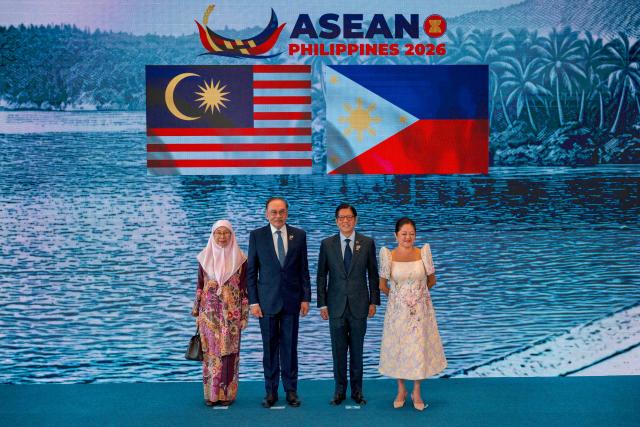 Malaysian Prime Minister Anwar Ibrahim (2nd-L) and his wife Wan Azizah Wan Ismail pose for a photo with Philippine President Ferdinand Marcos Jr. and his wife Liza Araneta Marcos during a welcome ceremony for the 48th Association of Southeast Asian Nations (ASEAN) summit in Cebu, central Philippines on May 8, 2026. (Photo by Ezra Acayan / POOL / AFP)