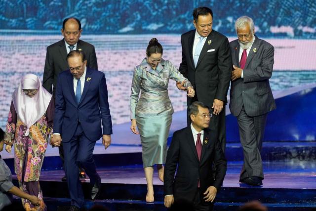 Wan Azizah Wan Ismail (L), wife of Malaysia's Prime Minister Anwar Ibrahim (2nd-L), Myanmar's Permanent Secretary of the Ministry of Foreign Affairs U Hau Khan Sum (back-L), Thailand's Prime Minister Anutin Charnvirakul (back-2nd-R), his wife Thananon Niramit, East Timor's Prime Minister Xanana Gusmao (R) and Vietnam's Prime Minister Le Minh Hung )front-R) leave the stage after a group photo during a welcome ceremony for the 48th Association of Southeast Asian Nations (ASEAN) summit in Cebu, central Philippines on May 8, 2026. (Photo by Aaron FAVILA / POOL / AFP)