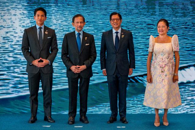 Brunei Sultan Hassanal Bolkiah (2nd-L) and his son Prince Abdul Mateen pose for a photo with Philippine President Ferdinand Marcos Jr. and his wife Liza Araneta Marcos during a welcome ceremony for the 48th Association of Southeast Asian Nations (ASEAN) summit in Cebu, central Philippines on May 8, 2026. (Photo by Ezra Acayan / POOL / AFP)