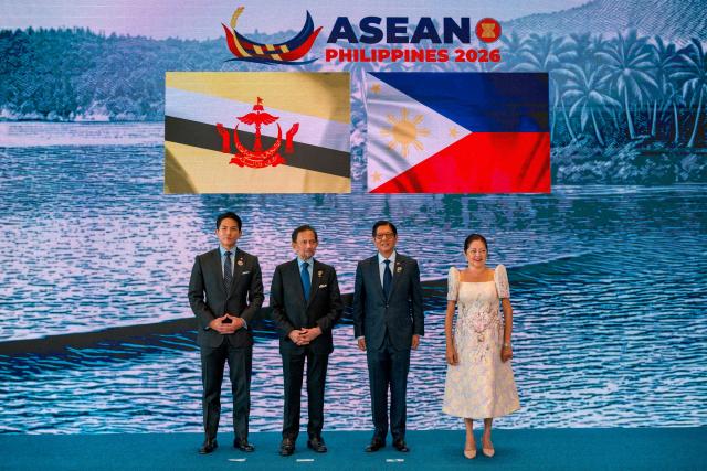 Brunei Sultan Hassanal Bolkiah (2nd-L) and his son Prince Abdul Mateen pose for a photo with Philippine President Ferdinand Marcos Jr. and his wife Liza Araneta Marcos during a welcome ceremony for the 48th Association of Southeast Asian Nations (ASEAN) summit in Cebu, central Philippines on May 8, 2026. (Photo by Ezra Acayan / POOL / AFP)